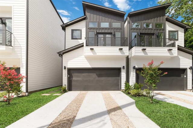 2109 Holman, Houston, TX 77004 - view of front of home featuring a balcony, board and batten siding, concrete driveway, and a garage