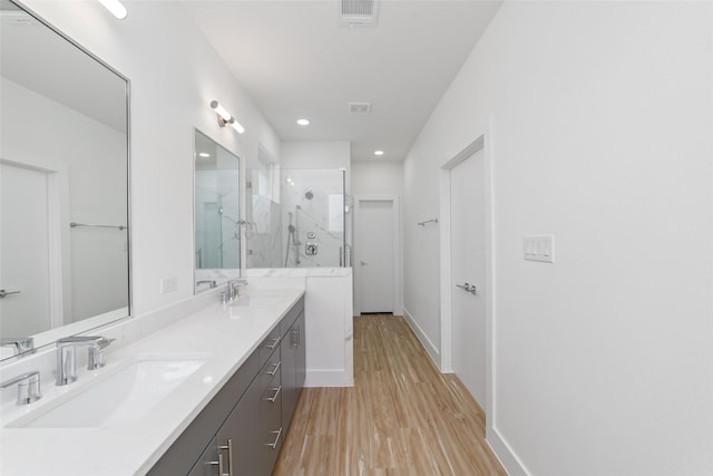 2109 Holman, Houston, TX 77004 - full bathroom with a marble finish shower, wood finished floors, double vanity, and recessed lighting