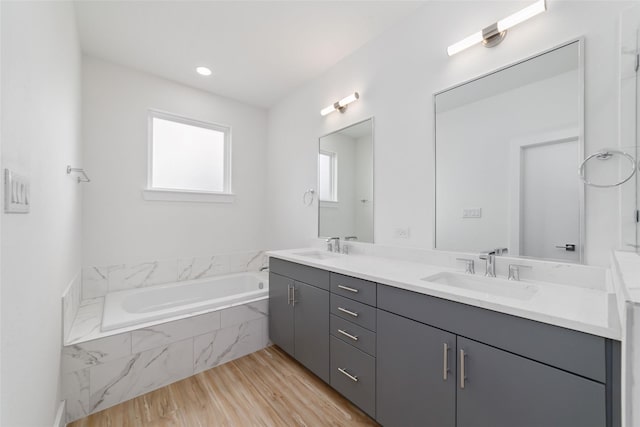 2109 Holman, Houston, TX 77004 - bathroom with double vanity, wood finished floors, and a bath