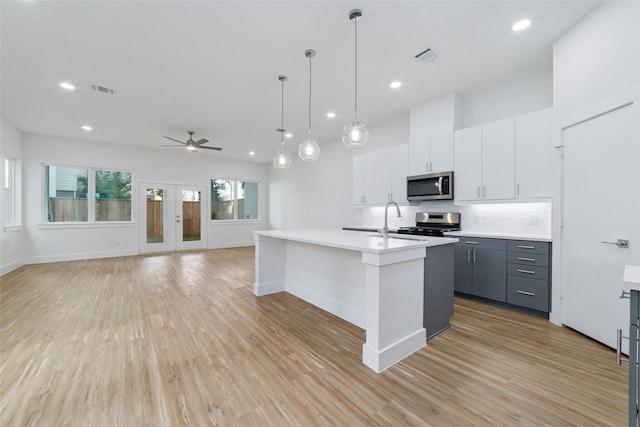 2109 Holman, Houston, TX 77004 - kitchen with stainless steel appliances, backsplash, light countertops, ceiling fan, and recessed lighting