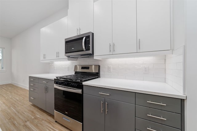 2109 Holman, Houston, TX 77004 - kitchen with appliances with stainless steel finishes, light wood-style floors, and light countertops