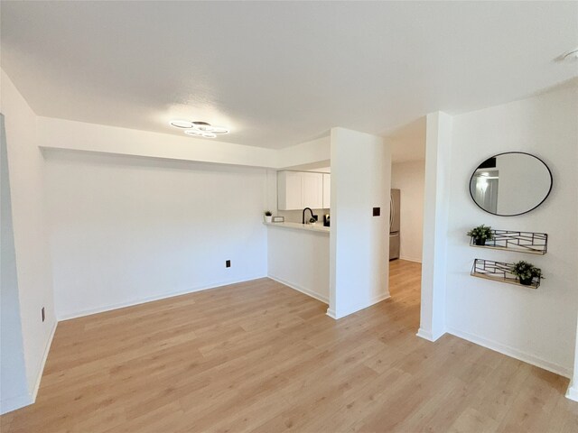 9090 S Braeswood Blvd Unit 115, Houston, TX 77074 - unfurnished living room featuring light wood-style flooring