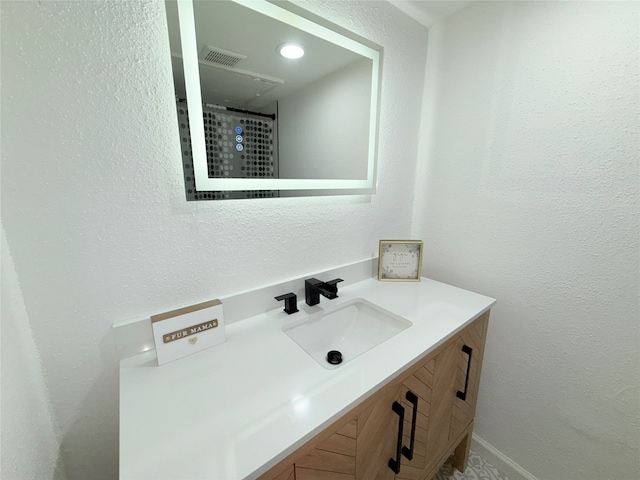 9090 S Braeswood Blvd Unit 115, Houston, TX 77074 - full bathroom with vanity and a textured wall