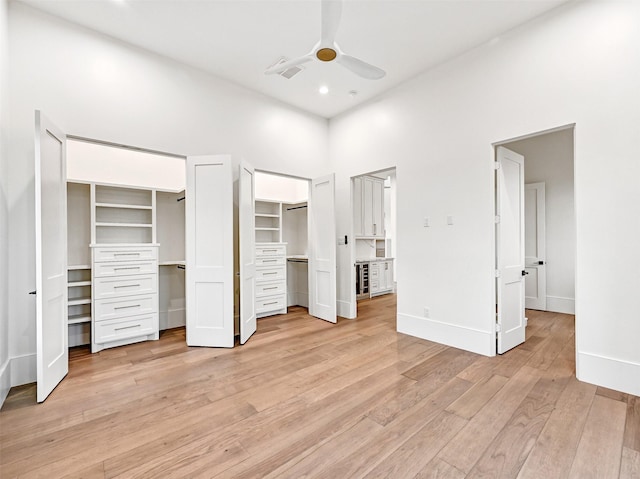 430 81st St, Galveston, TX 77554 - unfurnished bedroom featuring two closets, light wood finished floors, recessed lighting, and a ceiling fan