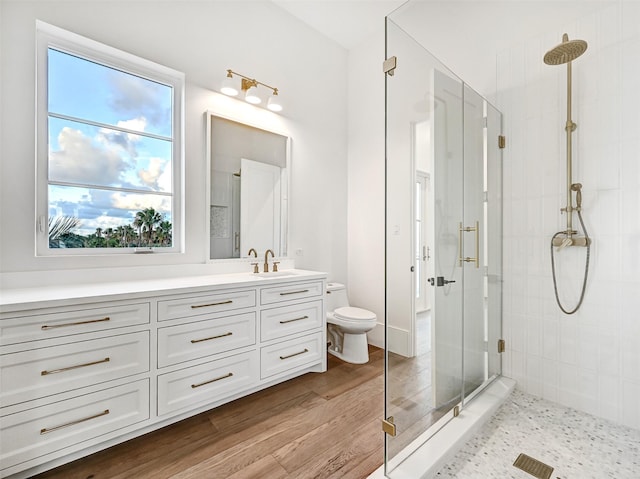 430 81st St, Galveston, TX 77554 - bathroom featuring a shower stall, vanity, and wood finished floors