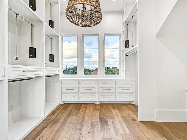 430 81st St, Galveston, TX 77554 - spacious closet with a chandelier and light wood finished floors