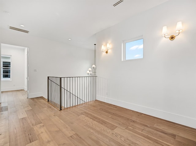 430 81st St, Galveston, TX 77554 - corridor with light wood-style floors and a chandelier