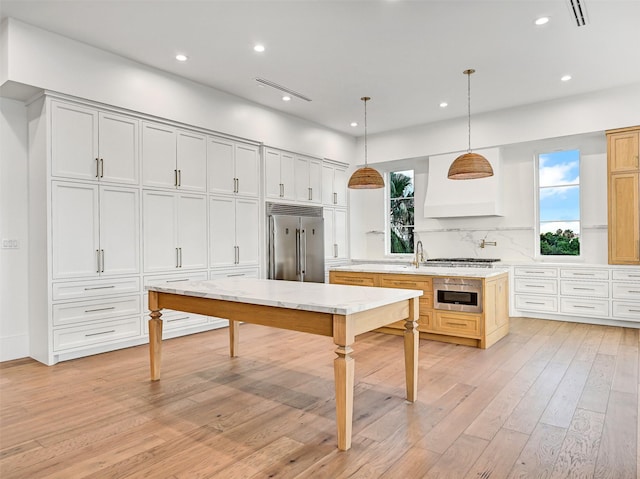 430 81st St, Galveston, TX 77554 - kitchen featuring stainless steel appliances, light wood-style flooring, recessed lighting, decorative backsplash, and custom exhaust hood