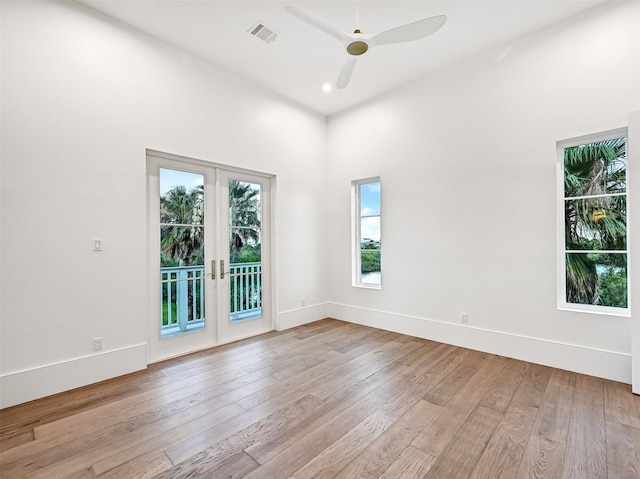 430 81st St, Galveston, TX 77554 - empty room with french doors, hardwood / wood-style flooring, a ceiling fan, recessed lighting, and a towering ceiling