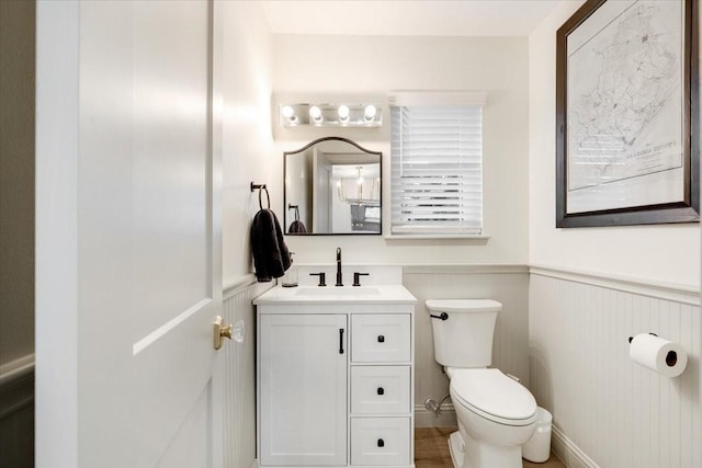 3220 Patricia Ln, Pearland, TX 77581 - half bath featuring vanity, a wainscoted wall, and a decorative wall