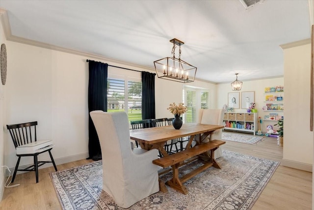 3220 Patricia Ln, Pearland, TX 77581 - dining room featuring a chandelier, crown molding, and light wood-style floors