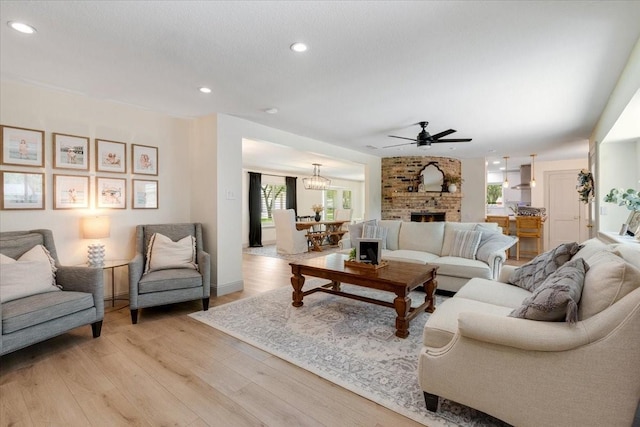 3220 Patricia Ln, Pearland, TX 77581 - living room with a ceiling fan, healthy amount of natural light, light wood-style flooring, recessed lighting, and a brick fireplace