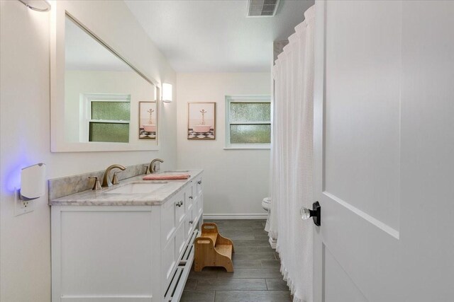 3220 Patricia Ln, Pearland, TX 77581 - full bathroom with double vanity and wood finished floors