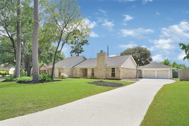 28207 Nancy Ln, Conroe, TX 77385 - view of front facade featuring a detached garage, a chimney, brick siding, driveway, and a shingled roof