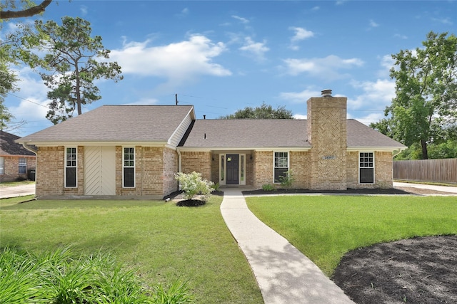 28207 Nancy Ln, Conroe, TX 77385 - single story home featuring brick siding, roof with shingles, and a chimney