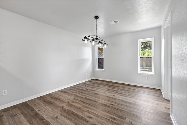 28207 Nancy Ln, Conroe, TX 77385 - spare room featuring wood finished floors and a chandelier
