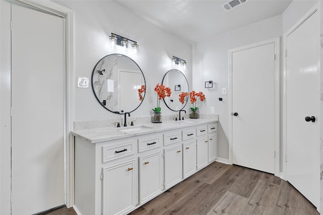 28207 Nancy Ln, Conroe, TX 77385 - bathroom featuring double vanity and wood finished floors