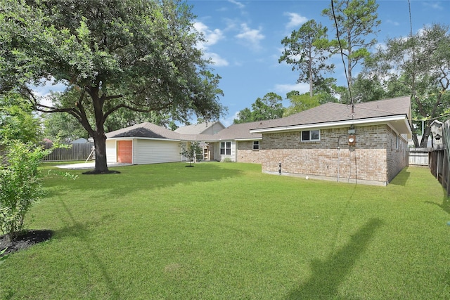 28207 Nancy Ln, Conroe, TX 77385 - back of property featuring brick siding, a fenced backyard, and a garage