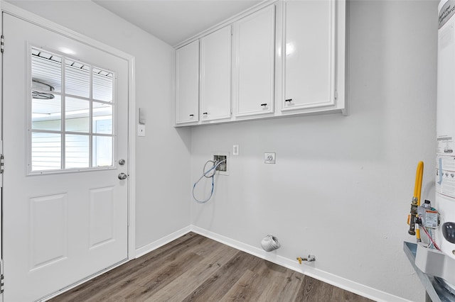 28207 Nancy Ln, Conroe, TX 77385 - laundry room featuring hookup for a washing machine, electric dryer hookup, wood finished floors, cabinet space, and hookup for a gas dryer