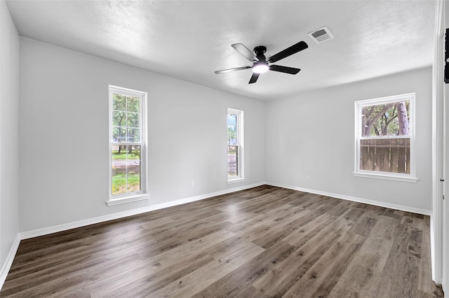 28207 Nancy Ln, Conroe, TX 77385 - spare room with healthy amount of natural light, wood finished floors, and a ceiling fan