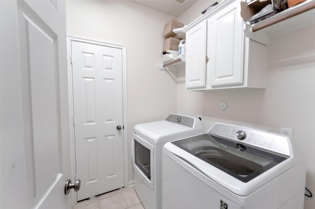 20710 Wagon Bridge Ln, Cypress, TX 77433 - laundry area with washing machine and dryer, cabinet space, and light tile patterned floors
