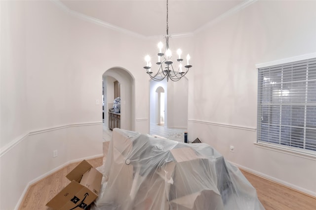 20710 Wagon Bridge Ln, Cypress, TX 77433 - dining space with arched walkways, a chandelier, wood finished floors, and crown molding