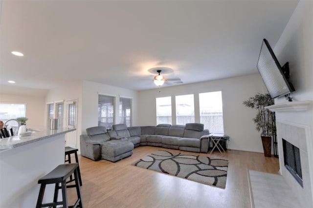 20710 Wagon Bridge Ln, Cypress, TX 77433 - living room with a ceiling fan, light wood-style floors, a fireplace with flush hearth, and recessed lighting