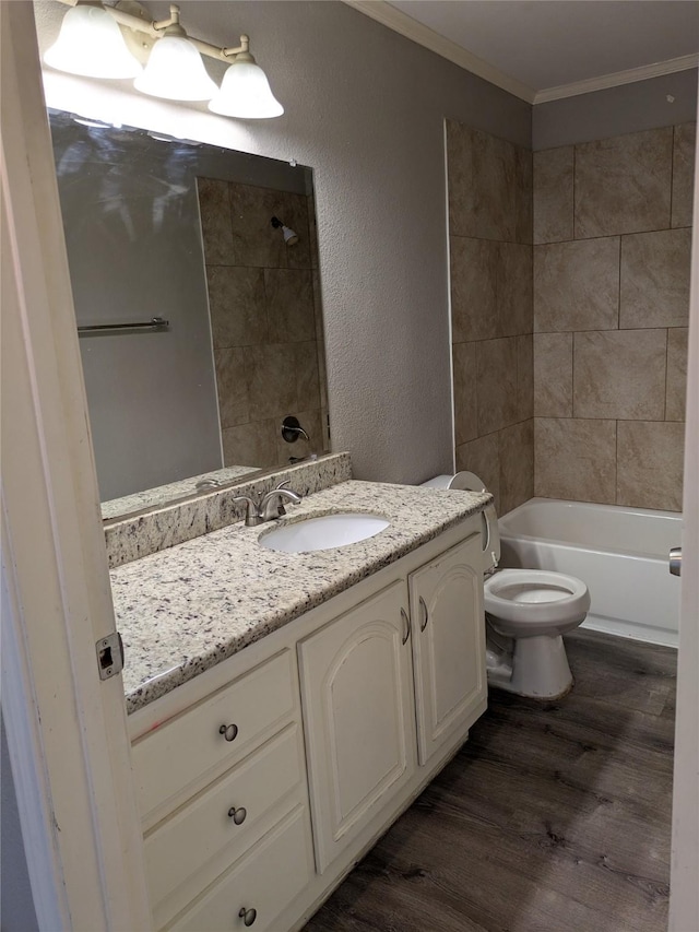 21402 Berry Ridge Ln, Tomball, TX 77375 - full bathroom with ornamental molding, vanity, wood finished floors, a textured wall, and washtub / shower combination