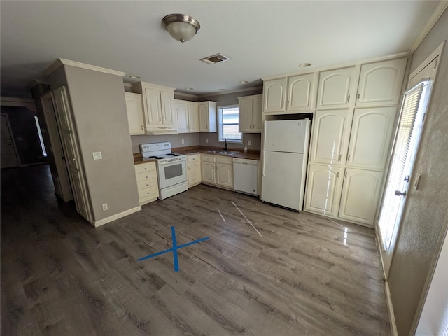21402 Berry Ridge Ln, Tomball, TX 77375 - kitchen featuring white appliances, crown molding, cream cabinets, dark wood finished floors, and under cabinet range hood
