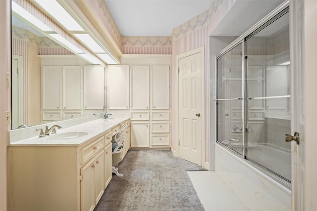 215 Enchanted Estates Dr, Crockett, TX 75835 - full bath featuring wallpapered walls, double vanity, and bath / shower combo with glass door