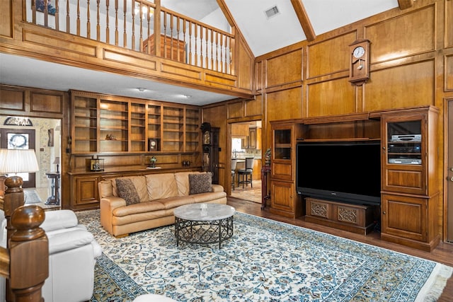 215 Enchanted Estates Dr, Crockett, TX 75835 - living area featuring high vaulted ceiling, wood finished floors, wooden walls, beamed ceiling, and built in features