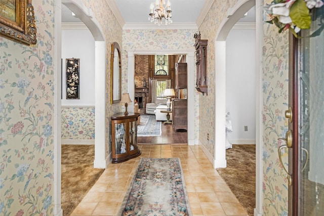 215 Enchanted Estates Dr, Crockett, TX 75835 - tiled foyer with wallpapered walls, arched walkways, ornamental molding, and a chandelier