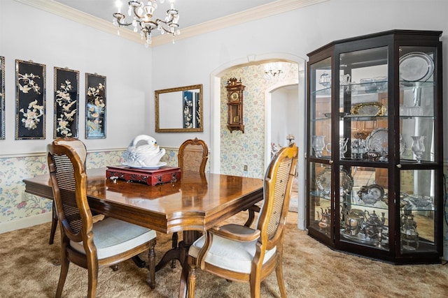 215 Enchanted Estates Dr, Crockett, TX 75835 - dining space featuring carpet flooring, a chandelier, arched walkways, crown molding, and wallpapered walls