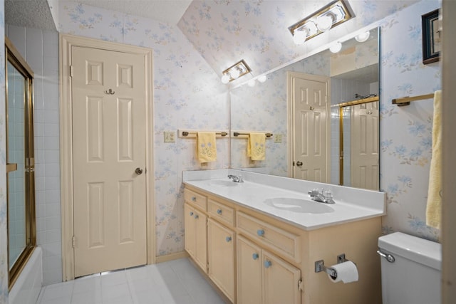 215 Enchanted Estates Dr, Crockett, TX 75835 - full bath featuring wallpapered walls, double vanity, tile patterned flooring, and enclosed tub / shower combo