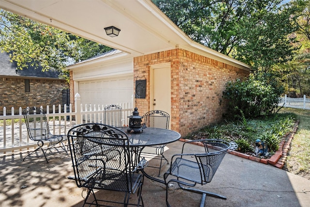 215 Enchanted Estates Dr, Crockett, TX 75835 - view of patio / terrace featuring outdoor dining space and an attached garage