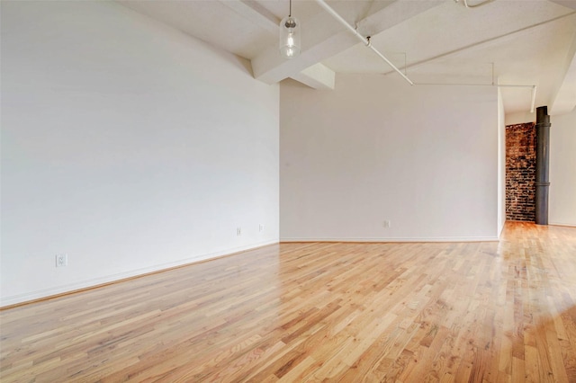 201 Main St Unit 5D, Houston, TX 77002 - empty room featuring light wood-style flooring and beamed ceiling