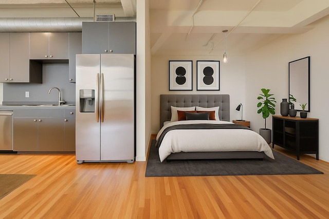 201 Main St Unit 5D, Houston, TX 77002 - bedroom with stainless steel fridge with ice dispenser and light wood-style floors