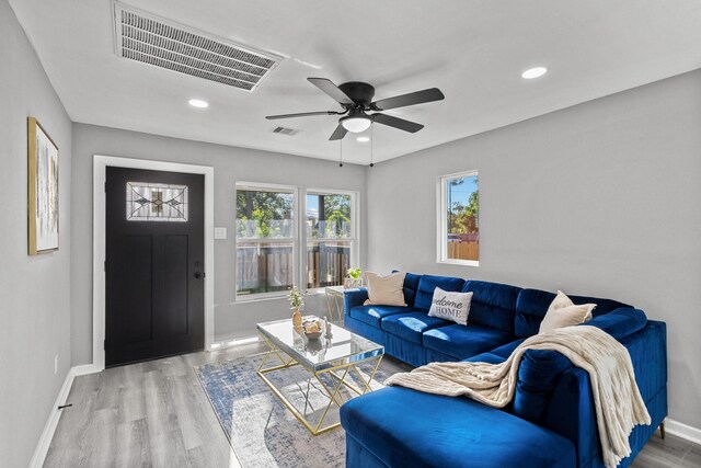 6810 Cohn St, Houston, TX 77091 - living area featuring wood finished floors, a ceiling fan, and recessed lighting