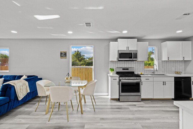 6810 Cohn St, Houston, TX 77091 - kitchen with appliances with stainless steel finishes, light countertops, tasteful backsplash, healthy amount of natural light, and recessed lighting
