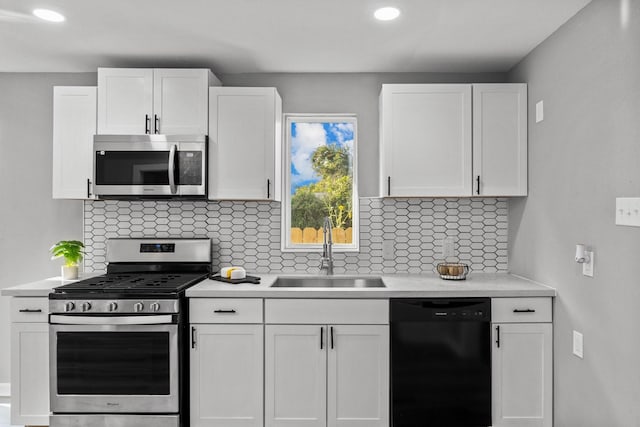 6810 Cohn St, Houston, TX 77091 - kitchen featuring stainless steel appliances, light countertops, white cabinetry, decorative backsplash, and recessed lighting