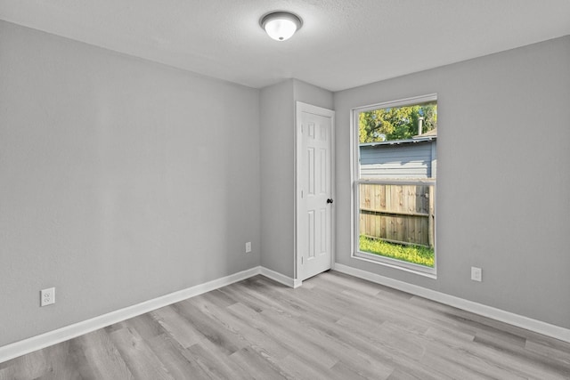 6810 Cohn St, Houston, TX 77091 - empty room with wood finished floors and a textured ceiling