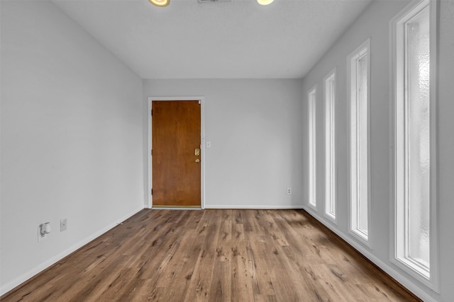 6437 Bayou Glen Rd, Houston, TX 77057 - spare room featuring baseboards and wood finished floors