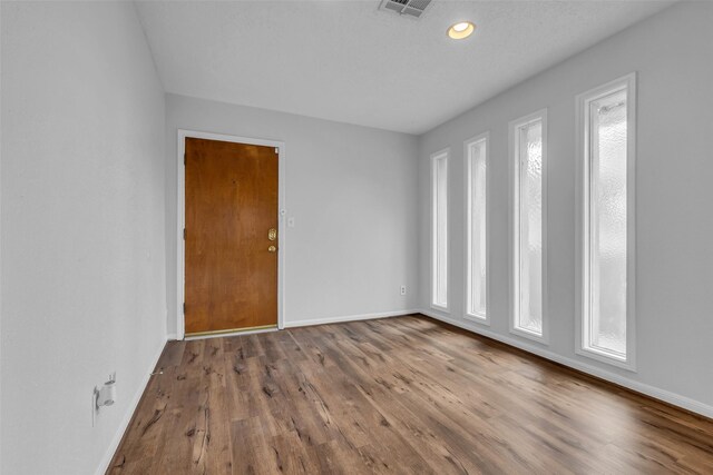 6437 Bayou Glen Rd, Houston, TX 77057 - spare room featuring wood finished floors, healthy amount of natural light, and recessed lighting