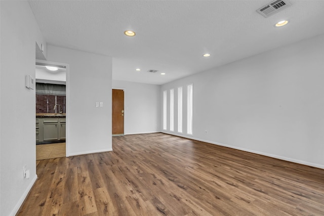 6437 Bayou Glen Rd, Houston, TX 77057 - empty room featuring wood finished floors and recessed lighting