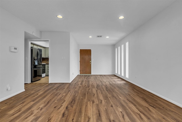 6437 Bayou Glen Rd, Houston, TX 77057 - empty room with dark wood-style floors and recessed lighting