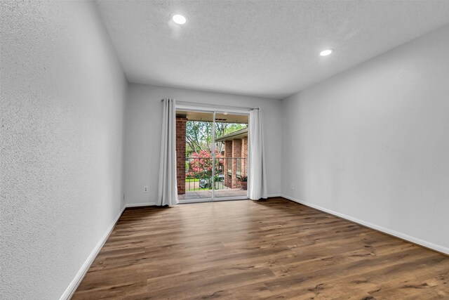 6437 Bayou Glen Rd, Houston, TX 77057 - unfurnished room featuring wood finished floors, a textured wall, recessed lighting, and a textured ceiling