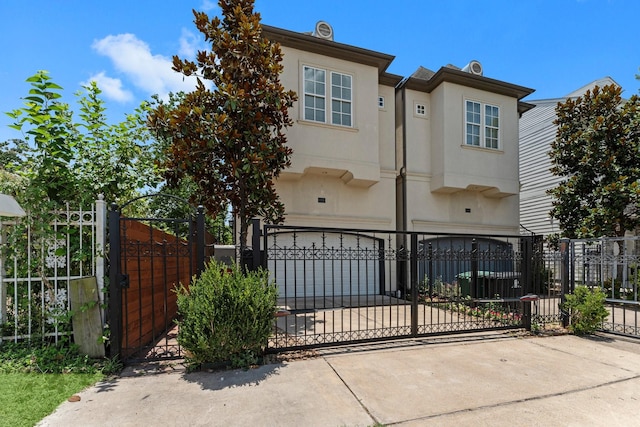 1038 E 29th St, Houston, TX 77009 - multi unit property with an attached garage, concrete driveway, a gate, and stucco siding