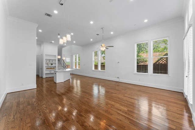 1038 E 29th St, Houston, TX 77009 - unfurnished living room featuring crown molding, healthy amount of natural light, ceiling fan, wood finished floors, and recessed lighting