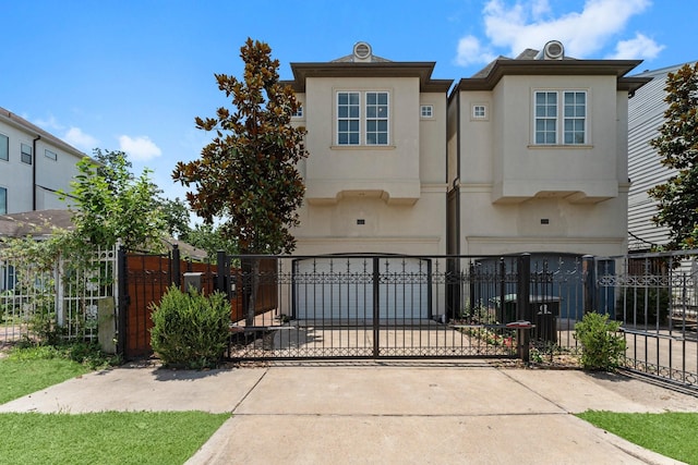 1038 E 29th St, Houston, TX 77009 - view of property with stucco siding, concrete driveway, and a gate