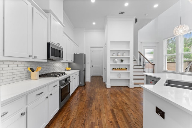 1038 E 29th St, Houston, TX 77009 - kitchen with stainless steel appliances, open shelves, white cabinetry, light countertops, and dark wood-style floors